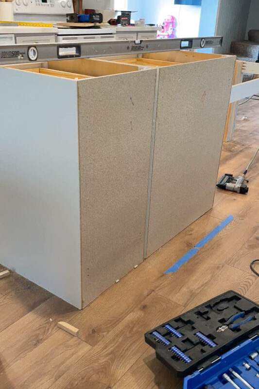 Adding paneling to the back of a kitchen island cabinet.